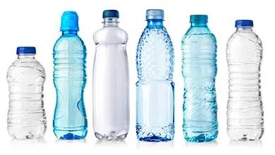 Six plastic water bottles of different shapes, sizes, and colors are lined up against a white background.